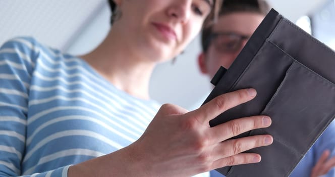 low angle shot of Businessman And Woman Using Digital Tablet