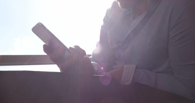 Business Man Talking On Cell Phone At Home with sun flares coming from window