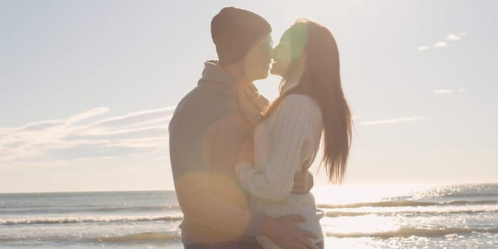 Cool Couple Laughing and hugging In Front Of Beach at beautiful autumn day