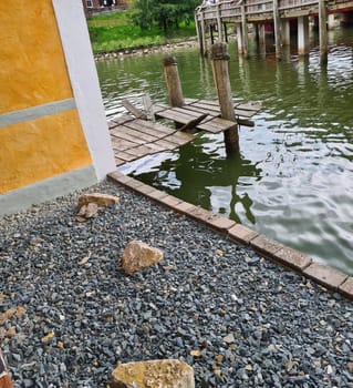 Background Broken wooden bridge of boards in the water of the lake