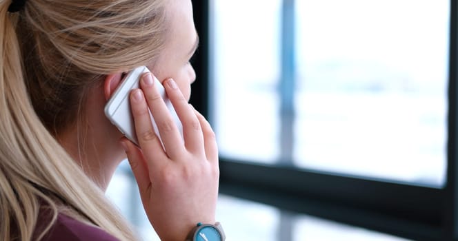 female manager using cell telephone in office interior