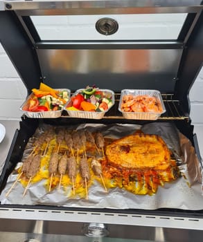 Grilled skewers with mixed vegetables served on a wooden cutting board with a vegan herb dip