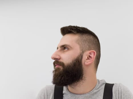 portrait of  young bearded hipster handyman isolated on white background