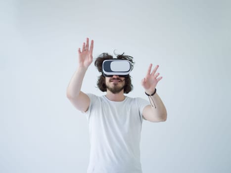 Happy man getting experience using VR headset glasses of virtual reality, isolated on white background