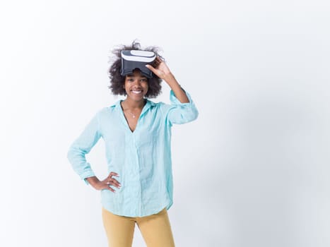 Happy african american girl getting experience using VR headset glasses of virtual reality, isolated on white background