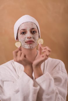 Spa Woman applying Facial Mask  Beauty Treatments  Close up portrait of beautiful girl with a towel on her head applying facial mask