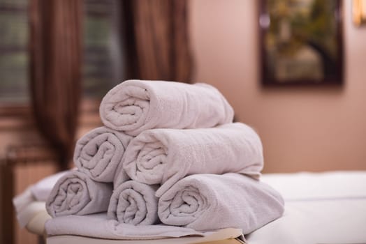 rolls of white towels in spa salon