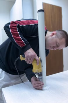 repairman working with drilling machine and assambling  furniture