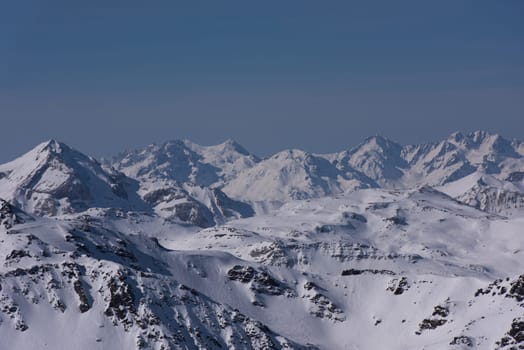 mountain landscape at winter with fresh snow on beautiful sunny day at french alps