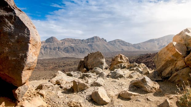 View from the high mountain on rocky dessert and valley at sunny day.
