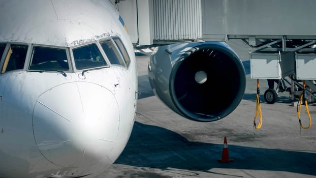 Photo of telescopic gate corridor for passenger connected to mosern airplane in airport terminal