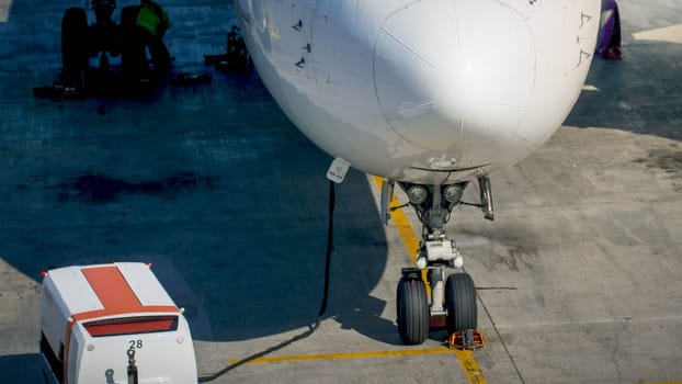 Charging airplane batteries during ground maintenance in airport.