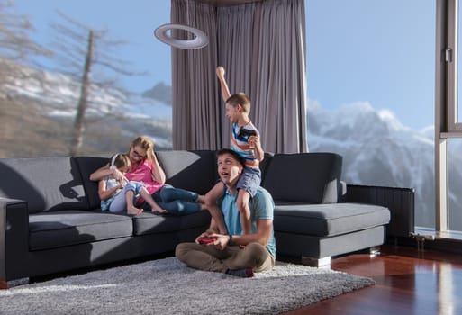 Happy family. Father, mother and children playing a video game Father and son playing video games together on the floor
