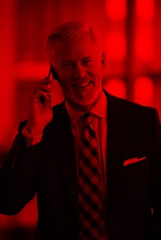 senior business man talk on mobile phone  at modern bright office interior