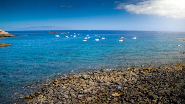 Lots of small wooden fishing boats moored in sea lagoon.