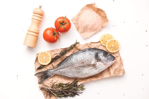 Raw dorada fish or gilt-head bream over white background, flat lay, top view.