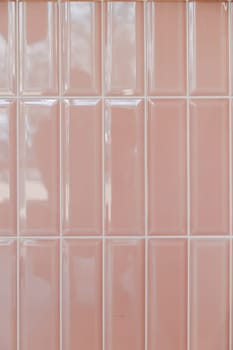 Pink glossy upright rectangular ceramic tile, background, texture.