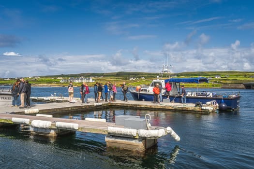 Portmagee, Ireland, August 2019 Group of tourists boarding a cruise boat to visit Skellig Michael island where Star Wars were filmed, Ring of Kerry