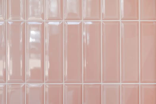 Pink glossy upright rectangular ceramic tile, background, texture.