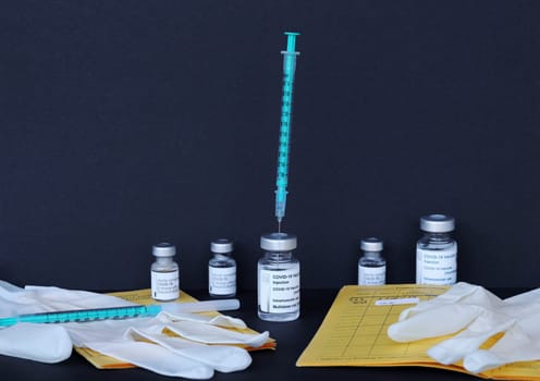 Corona Covid-19 vaccination with vaccination card, vaccination bottles and syringes