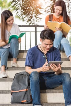 Happy young Asian man and woman students intend to reading books at university, Education back to university concept