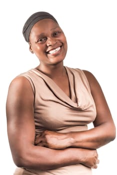 Three quarter portrait of an African lady, in her early fourtees, with a big beautiful smile on a white background. She wears a light brown sleeveles top and a grey head cover.
