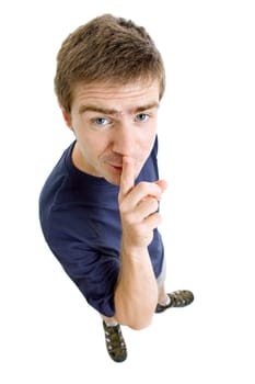 young casual man full body with his finger on lips