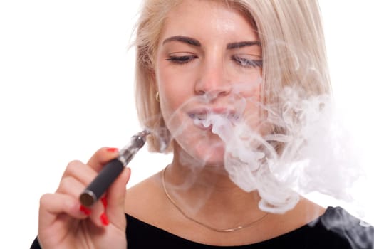 Young woman smokes an e-cigarette with blonde hair portrait isolated against white background