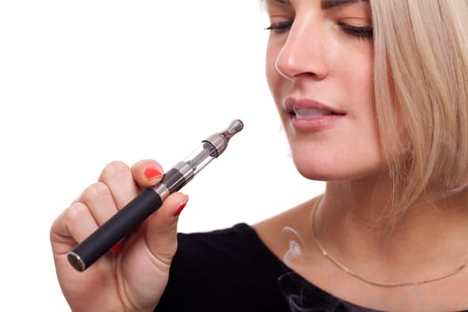 Young woman smokes an e-cigarette with blonde hair portrait isolated against white background