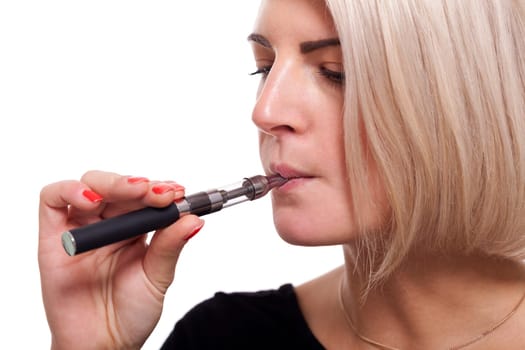 Young woman smokes an e-cigarette with blonde hair portrait isolated against white background