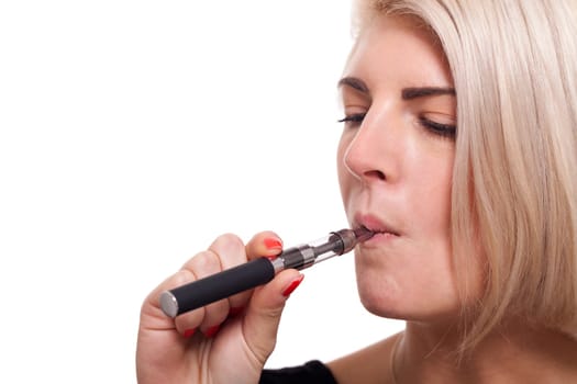 Young woman smokes an e-cigarette with blonde hair portrait isolated against white background