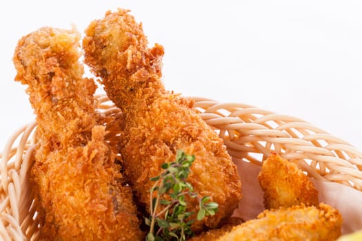 Crispy fried chicken wings with a dip on a plate insulated against a white background