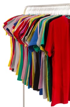 Colored shirts on hangers in a row. Isolate on white.