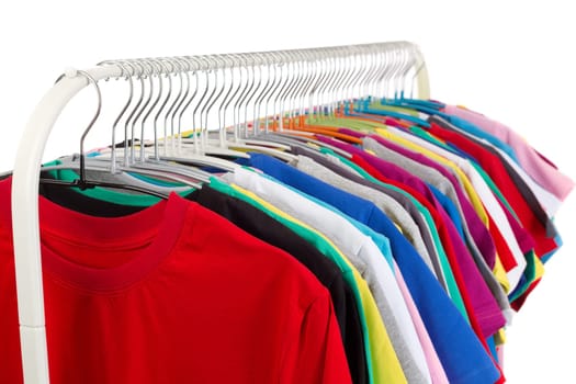 Multi colored shirts on wooden hangers. Isolate on white.
