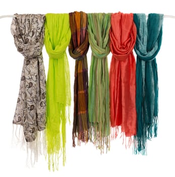 Silk colored scarves on a hanger. Isolate on white.