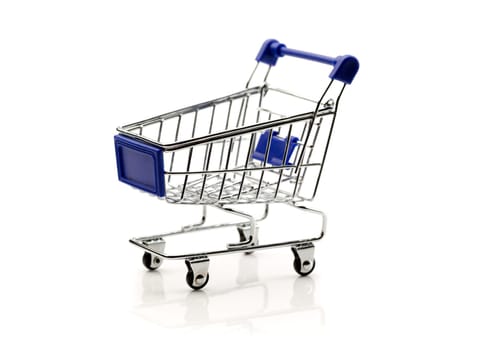 Miniature empty supermarket trolley. Isolate on white background.
