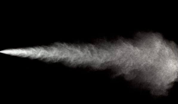 Spraying of water in motion on black background