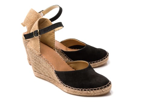 Pair of beige with black suede women's summer shoes. Isolate on white.