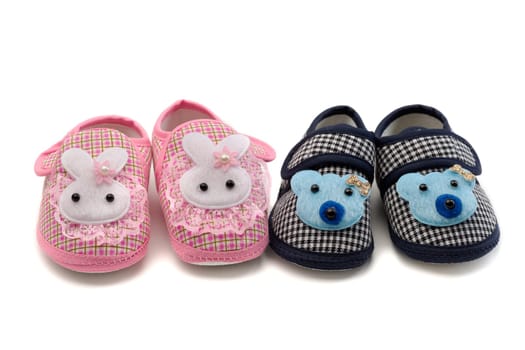 Two pairs of baby shoes, pink and blue. Isolate on white.