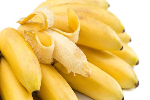 Bunch of bananas with open one isolated on white.