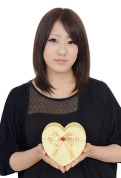 Happy young asian woman holding a gift box