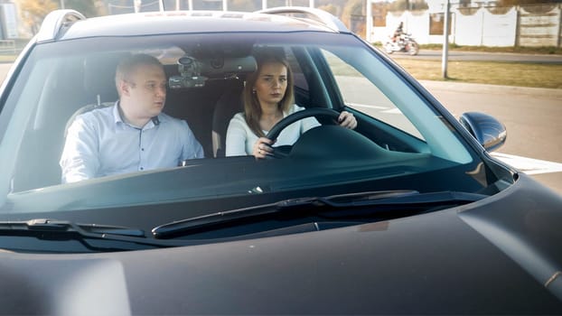 Portrait of upset angry woman with husband driving a car.