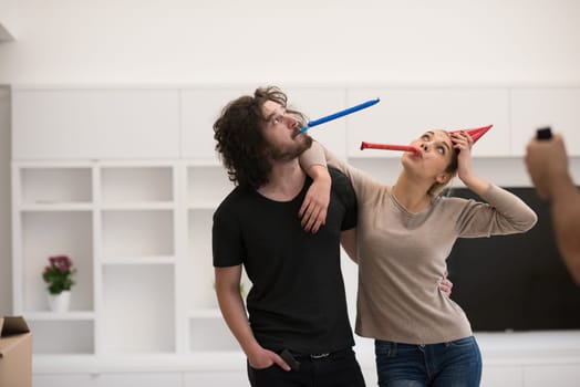 young romantic  couple in love  celebrating and blowing confetti decorations