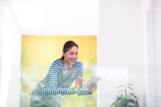 beautiful young woman at home websurfing on internet with tablet