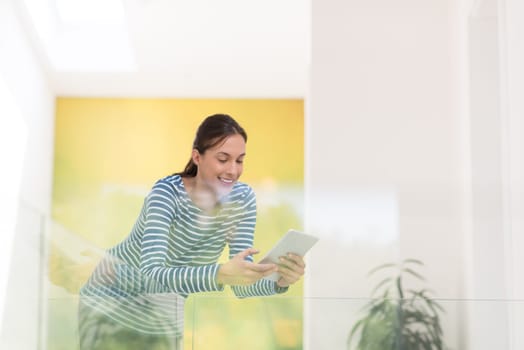 beautiful young woman at home websurfing on internet with tablet