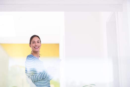 beautiful young woman at home websurfing on internet with tablet