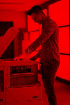 young business man copy documents on copy machine at modern startup office interior, casual clothes