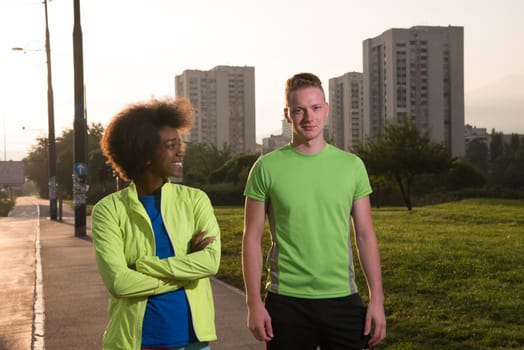 portrait of a young African American beautiful woman and a young man jogging in the city