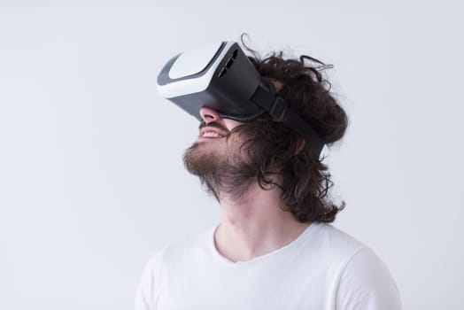 Happy man getting experience using VR headset glasses of virtual reality, isolated on white background