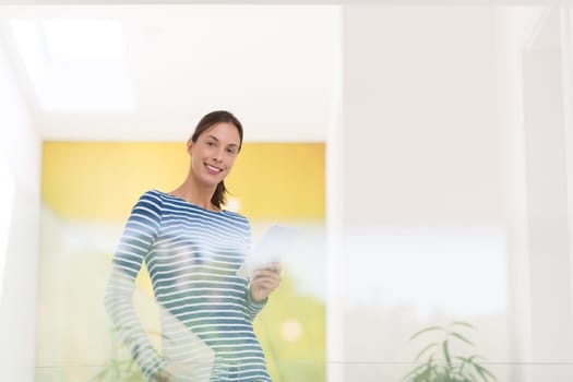 beautiful young woman at home websurfing on internet with tablet